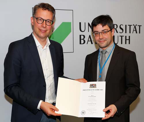 Dr. Sebastian Bange erhält den „Preis für gute Lehre 2021“ von Wissenschaftsminister Markus Blume. (Foto: © Peter Kolb)